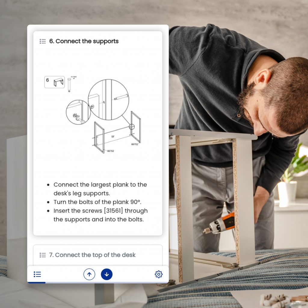 Un hombre monta un mueble siguiendo instrucciones digitales en un móvil.