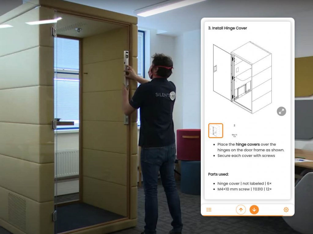 Instalador montando la vaina acústica mientras sigue instrucciones digitales en una tableta.